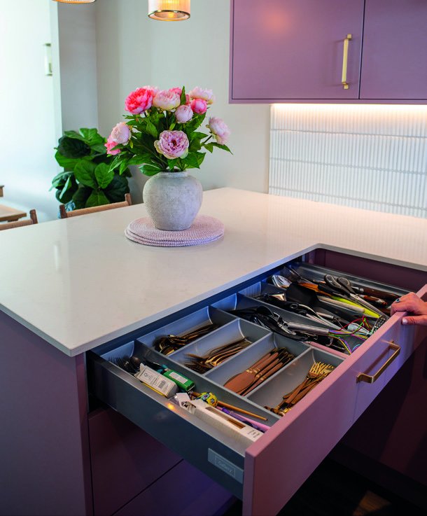 Extra-large cutlery drawer open beneath the white worktop